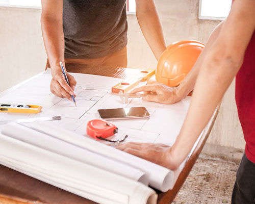 construction worker looking over blueprints