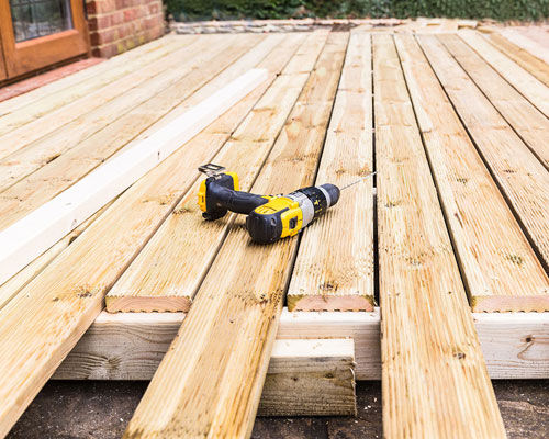 drill laying on the wooden porch of a home