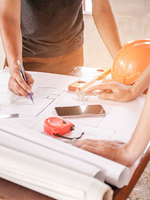 construction worker looking over blueprints