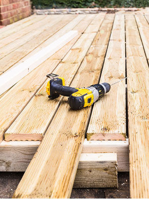 drill laying on the wooden porch of a home